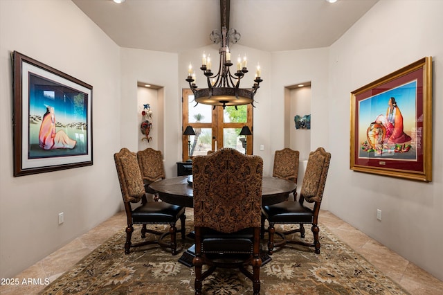 dining area with a chandelier and vaulted ceiling