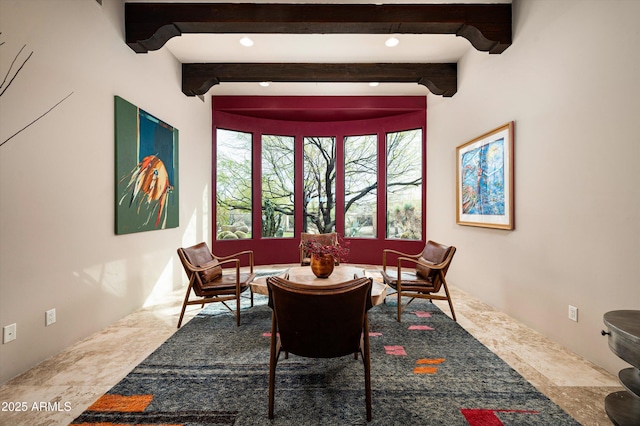 living area with beam ceiling