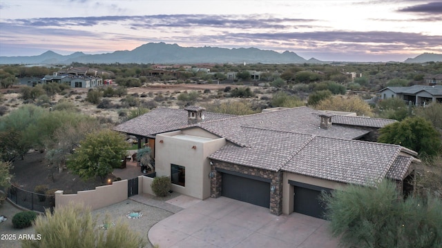 view of front of home with a mountain view and a garage