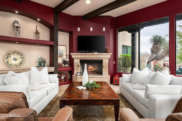 living room featuring a high end fireplace and beam ceiling