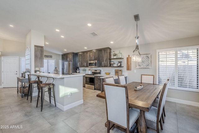 dining space featuring recessed lighting, baseboards, visible vents, lofted ceiling, and light tile patterned flooring