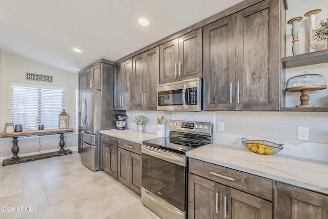 kitchen with light tile patterned floors, lofted ceiling, light stone countertops, stainless steel appliances, and open shelves