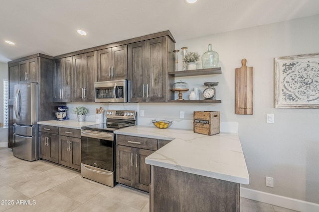 kitchen featuring stainless steel appliances, light stone counters, dark brown cabinets, and open shelves