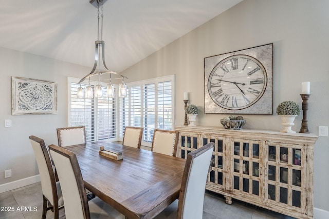 tiled dining area featuring vaulted ceiling, baseboards, and an inviting chandelier