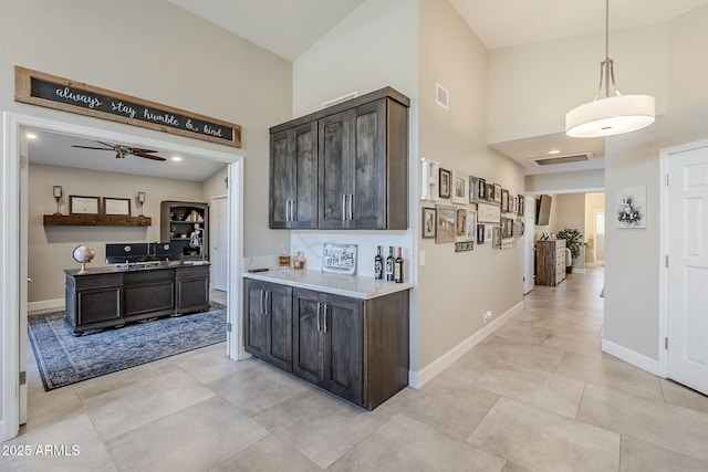 kitchen featuring baseboards, visible vents, and a ceiling fan