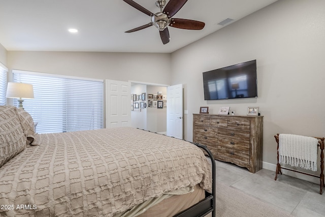 bedroom with light colored carpet, lofted ceiling, visible vents, and a ceiling fan