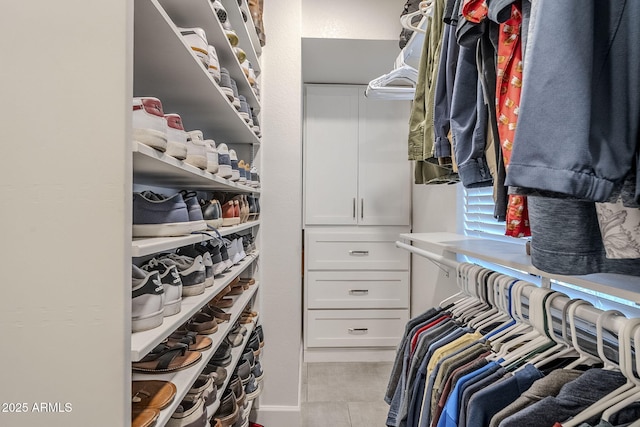 spacious closet featuring light tile patterned flooring