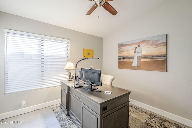 office area with vaulted ceiling, ceiling fan, light tile patterned floors, and baseboards