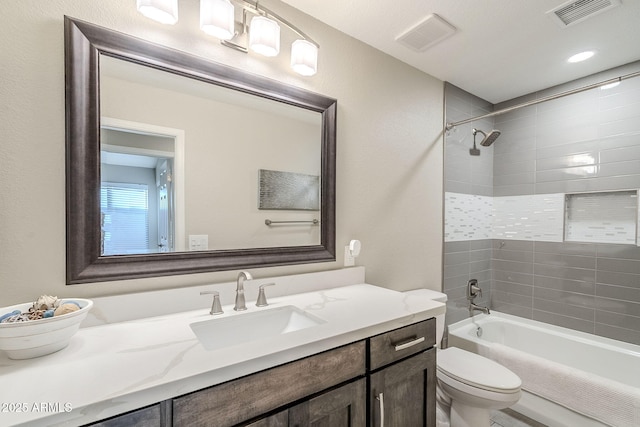 bathroom with visible vents, vanity, toilet, and shower / bathtub combination