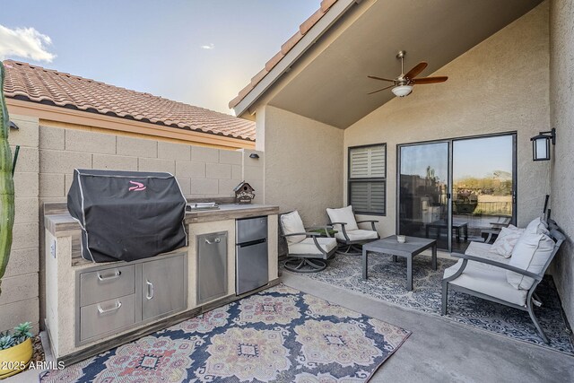 view of patio / terrace with fence, a ceiling fan, and area for grilling