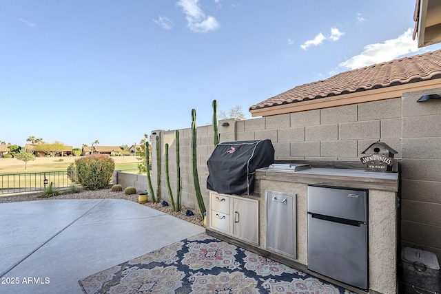 view of patio featuring a grill, area for grilling, and fence