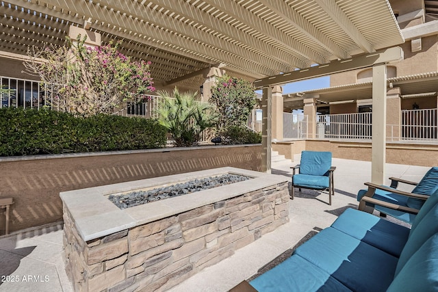 view of patio / terrace with an outdoor fire pit, fence, and a pergola