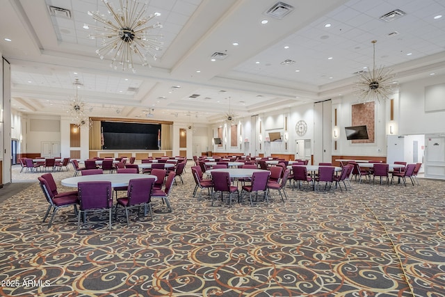 dining room with a chandelier, a raised ceiling, and visible vents