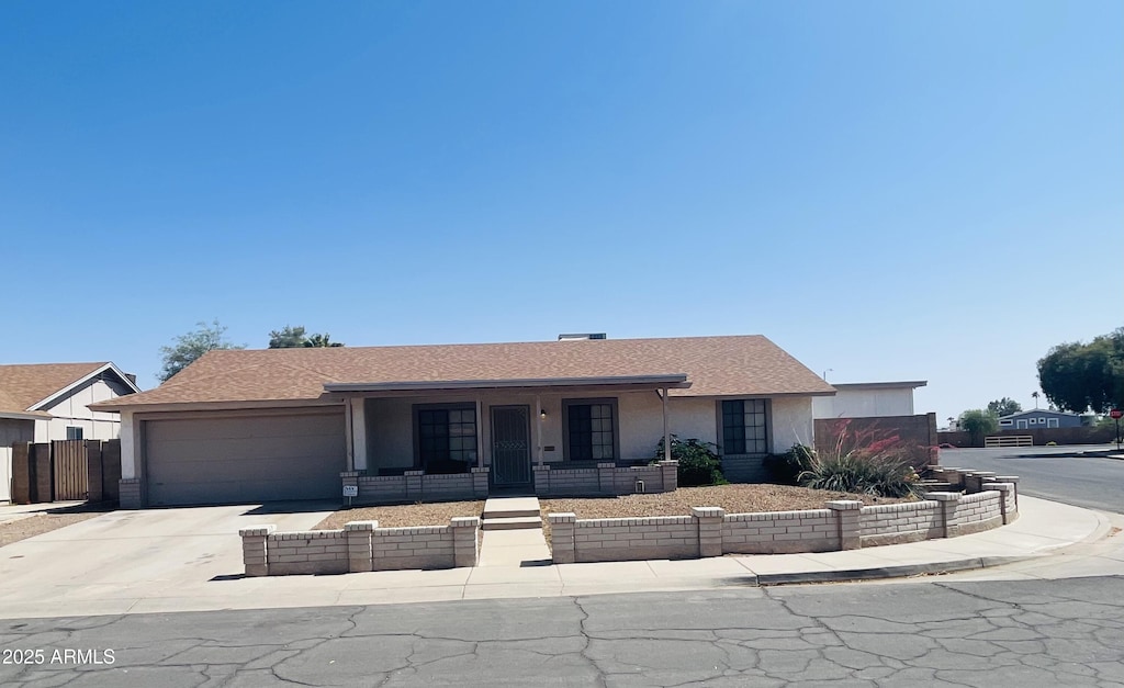 405 E Providence Dr, Casa Grande, AZ 85122 - ranch-style house with an attached garage, a porch, stucco siding, concrete driveway, and fence