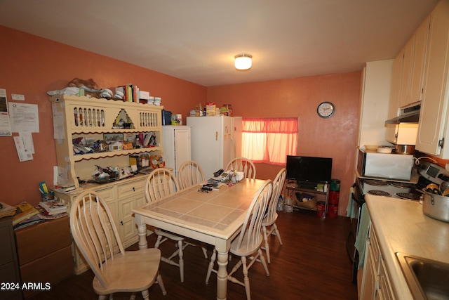 dining area with dark hardwood / wood-style flooring