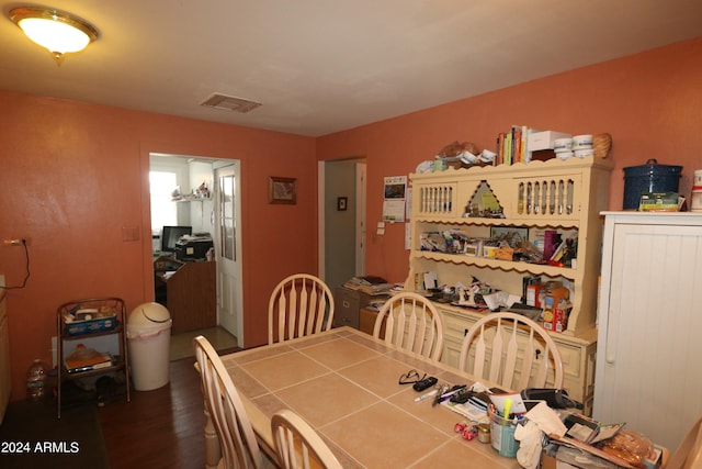 dining space with dark hardwood / wood-style floors