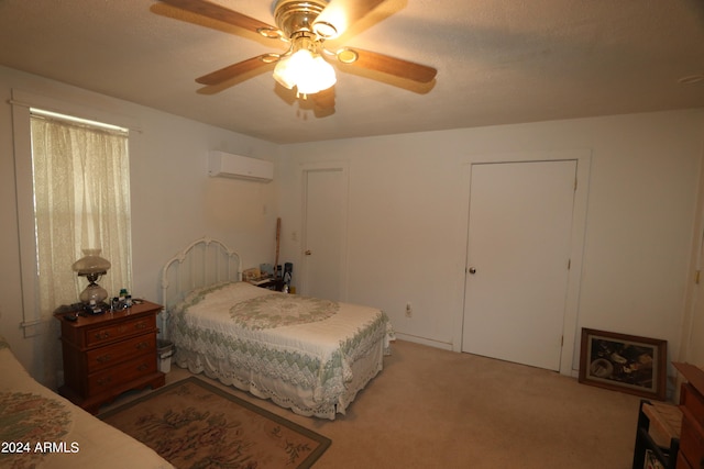 carpeted bedroom with a textured ceiling, a wall mounted air conditioner, and ceiling fan