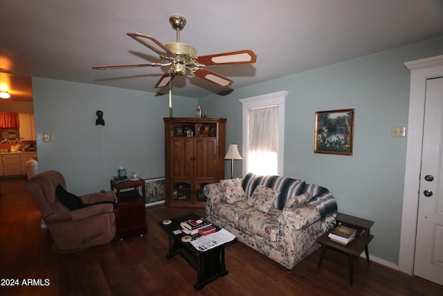 living room featuring dark wood-type flooring and ceiling fan