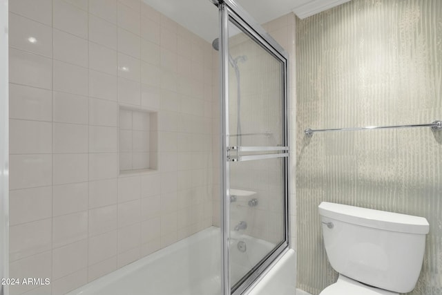 bathroom featuring shower / bath combination with glass door and toilet