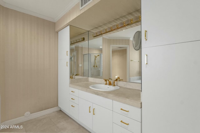 bathroom with tile patterned floors, vanity, an enclosed shower, and crown molding