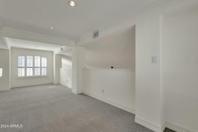 unfurnished room featuring light carpet and crown molding