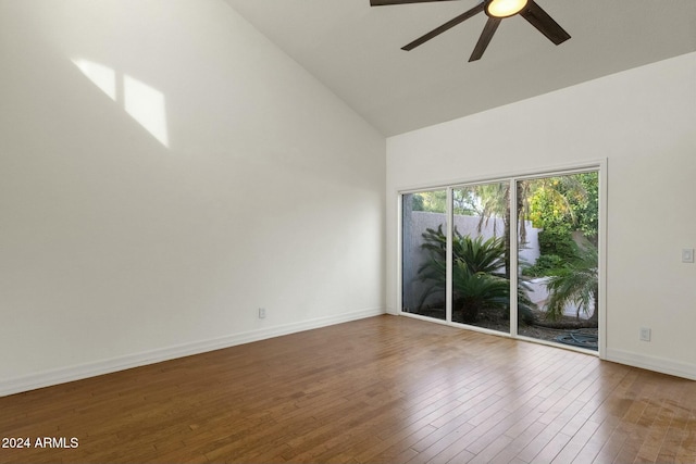 empty room featuring hardwood / wood-style floors, high vaulted ceiling, and ceiling fan