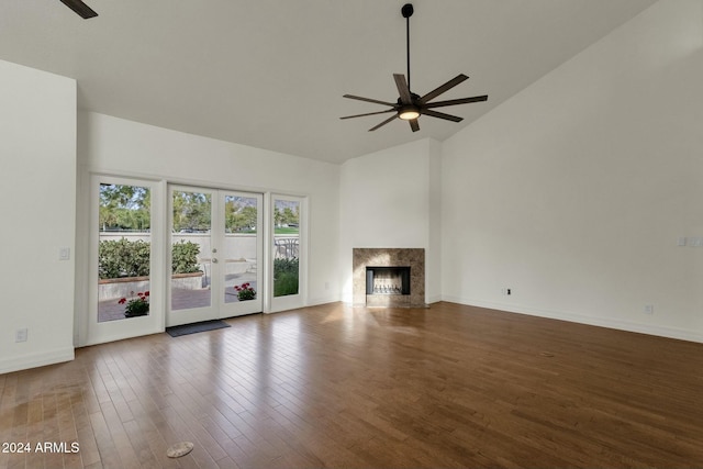 unfurnished living room featuring ceiling fan, dark hardwood / wood-style flooring, high vaulted ceiling, and french doors