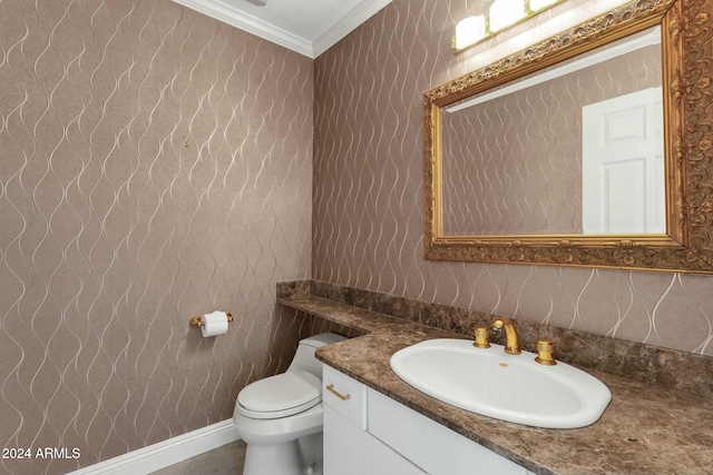 bathroom with vanity, toilet, and ornamental molding