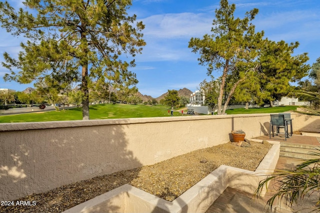 surrounding community featuring a mountain view and a yard