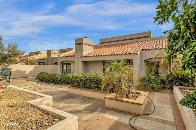 rear view of property featuring a patio