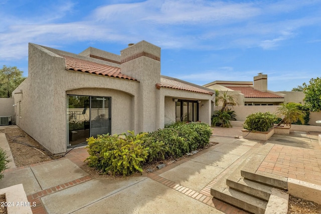 exterior space with a patio and central AC