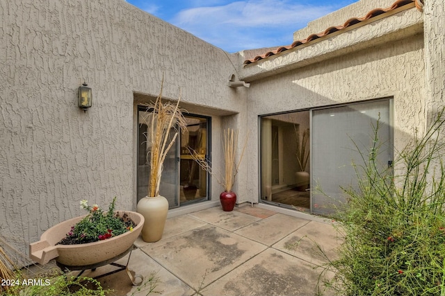 doorway to property with a patio area