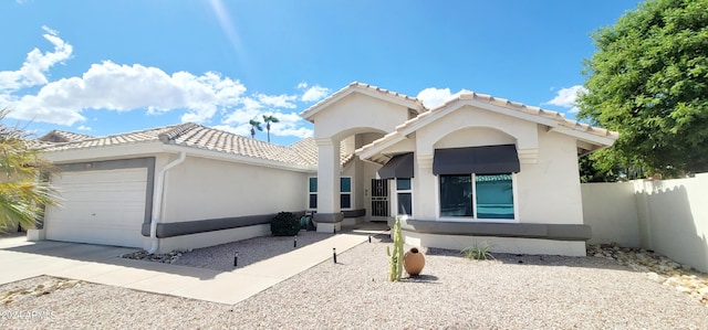 mediterranean / spanish house with a garage