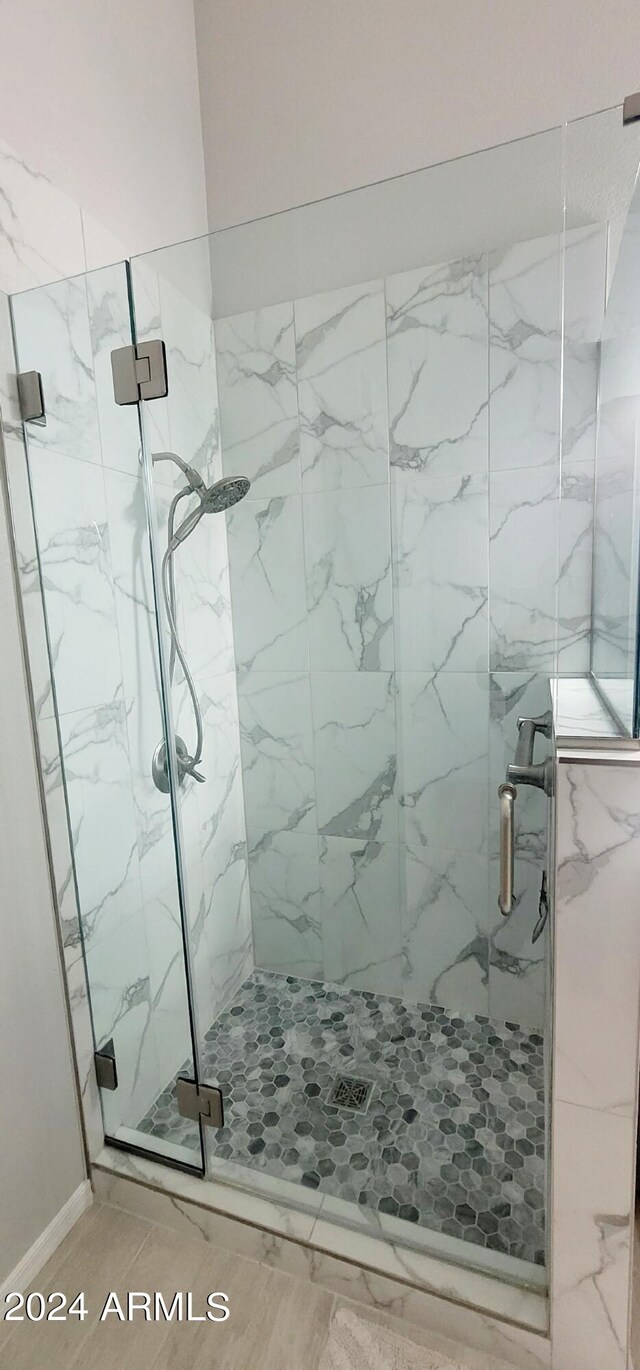 bathroom featuring a shower with door