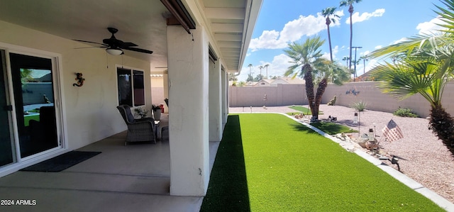 view of yard featuring a patio area and ceiling fan