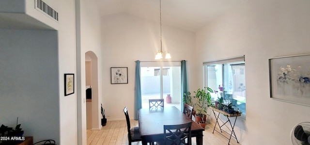 dining space with a chandelier and high vaulted ceiling