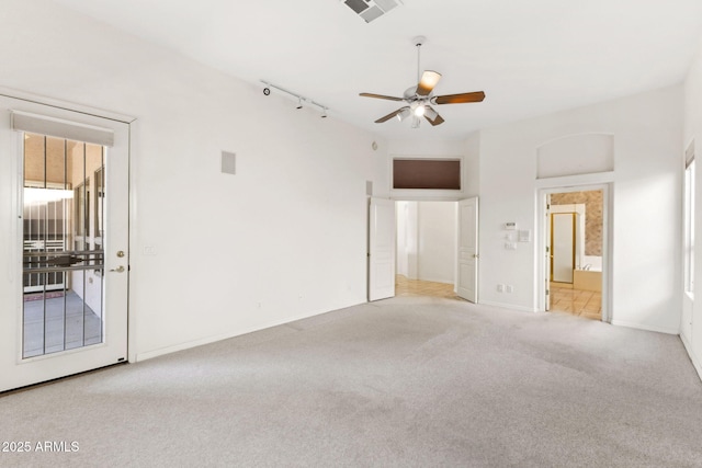 unfurnished bedroom featuring carpet floors, visible vents, baseboards, rail lighting, and ensuite bath