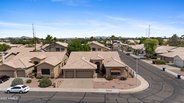 view of front of home featuring a residential view, an attached garage, stucco siding, concrete driveway, and a tiled roof