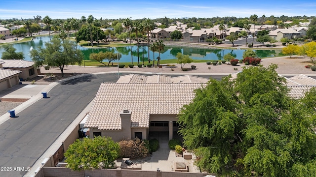 drone / aerial view with a water view and a residential view