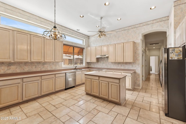 kitchen with light brown cabinetry, ceiling fan, appliances with stainless steel finishes, arched walkways, and under cabinet range hood
