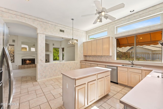 kitchen featuring a sink, light brown cabinets, dishwasher, and visible vents