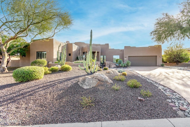 pueblo-style home featuring a garage