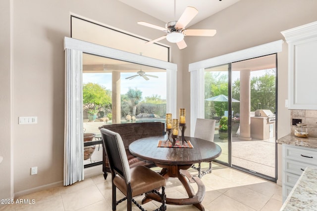 dining area featuring light tile patterned floors, vaulted ceiling, and ceiling fan