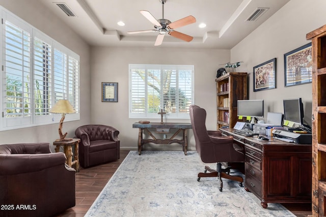 office featuring a raised ceiling and ceiling fan