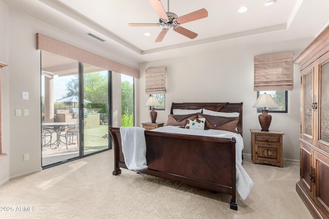 bedroom featuring multiple windows, light carpet, access to outside, and ceiling fan