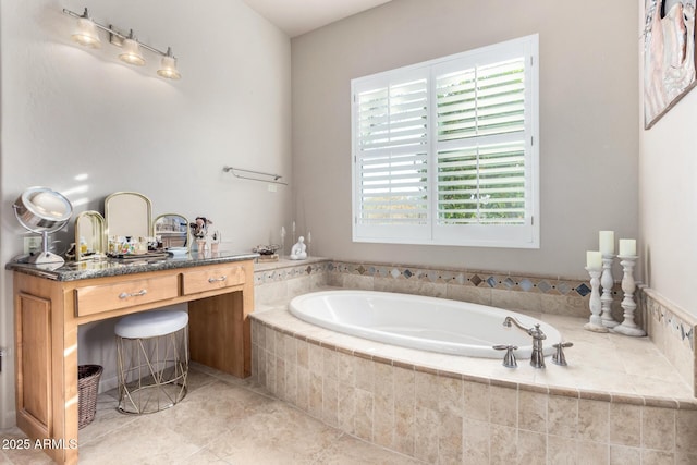 bathroom with vanity and tiled tub