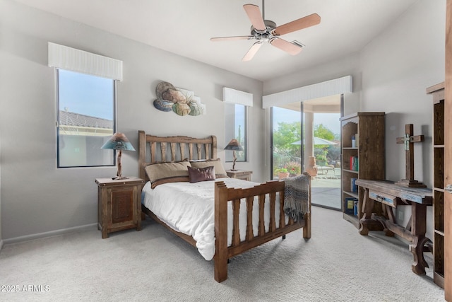 carpeted bedroom with ceiling fan and access to exterior