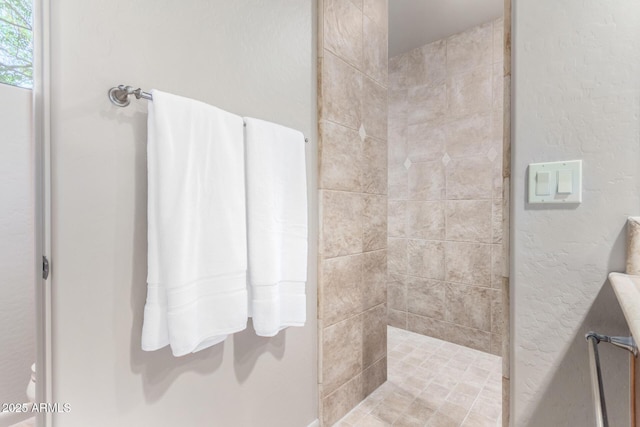 bathroom with a tile shower