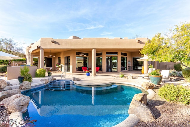 view of pool with a patio area and ceiling fan