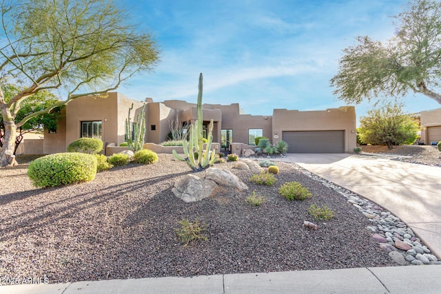 pueblo-style home with a garage